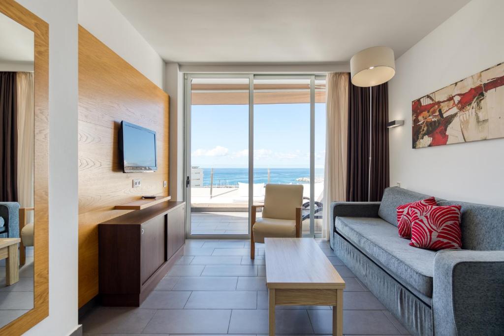 a living room with a couch and a table at Holiday Club Puerto Calma in Puerto Rico de Gran Canaria