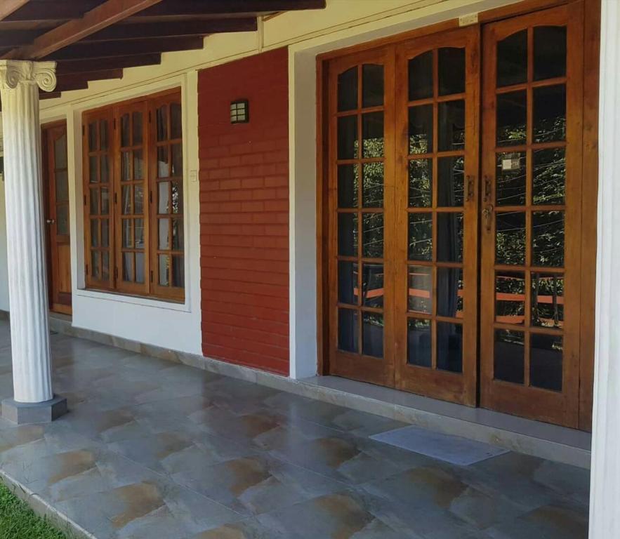 a house with wooden doors and a pillar at No.11 Uptown EconoStay in Kandy