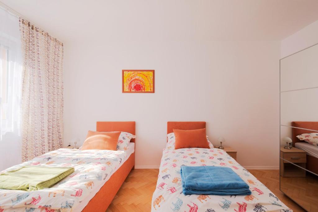 a bedroom with two beds and a mirror at Terasa Capajevova 6 Kosice in Košice