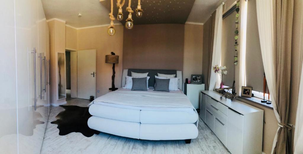 um quarto com uma cama grande e um grande repousa-pés em Best City Apartment em Hanôver
