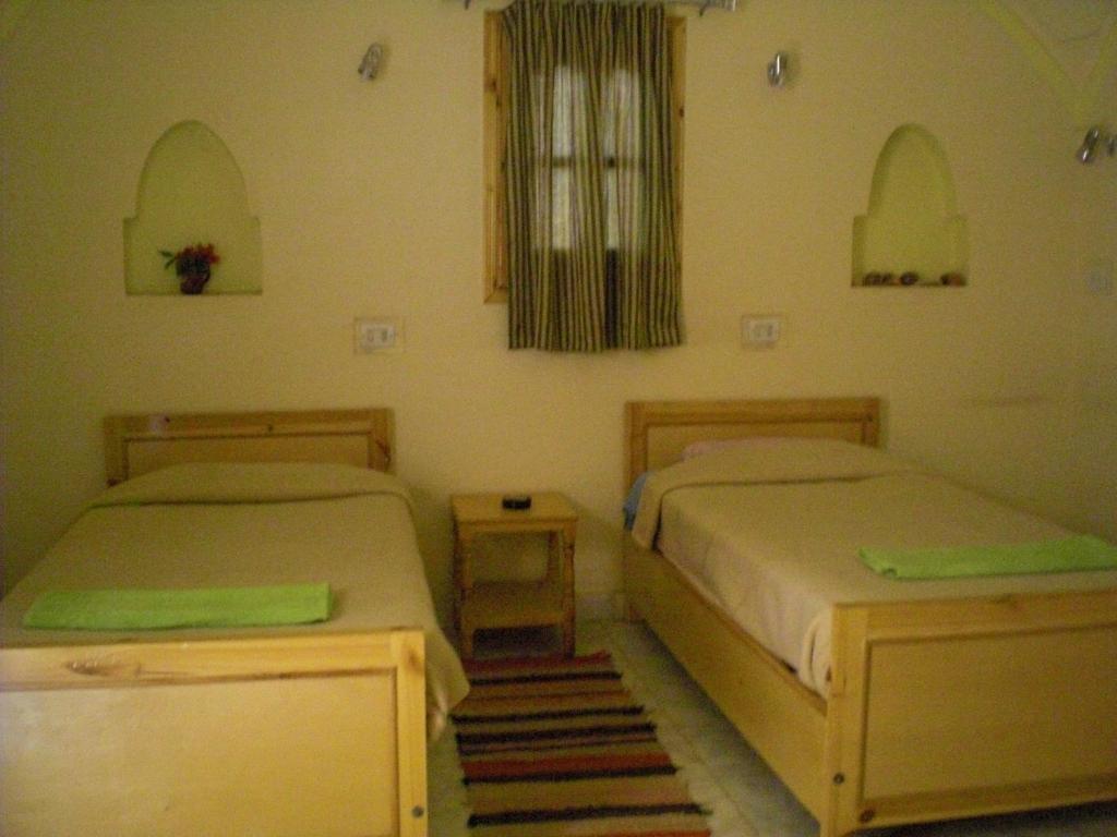 Postel nebo postele na pokoji v ubytování El Fayrouz Hotel