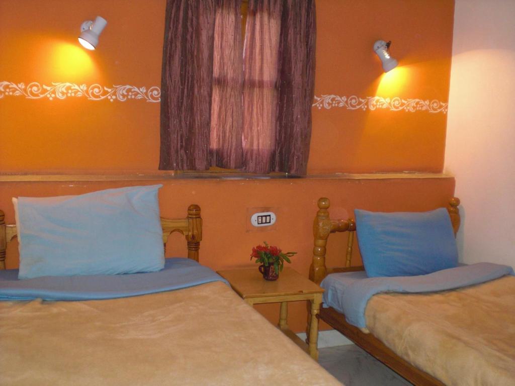 Postel nebo postele na pokoji v ubytování El Fayrouz Hotel