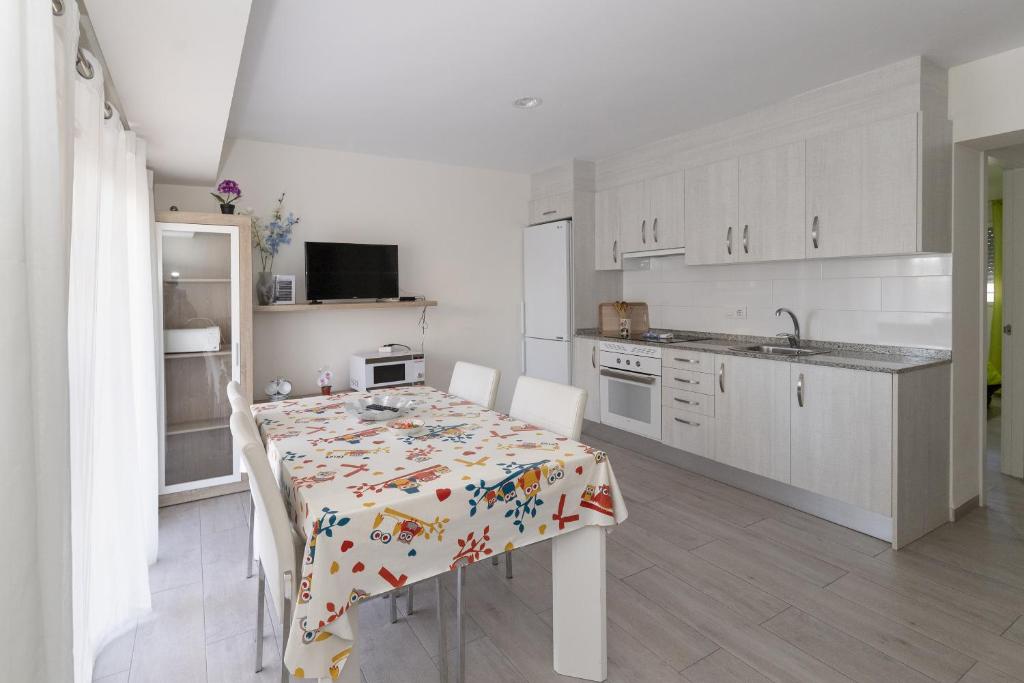 a kitchen with a table with a tablecloth on it at Trompeta Azul in Denia