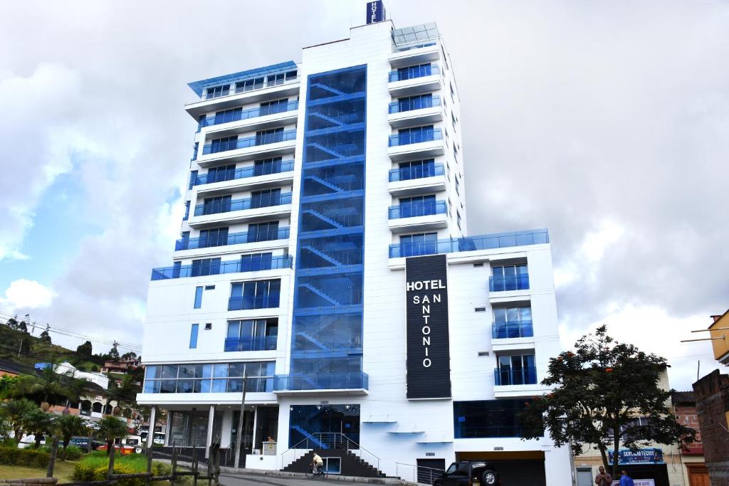 a tall white building with a sign on it at Hotel San Antonio Guarne in Guarne