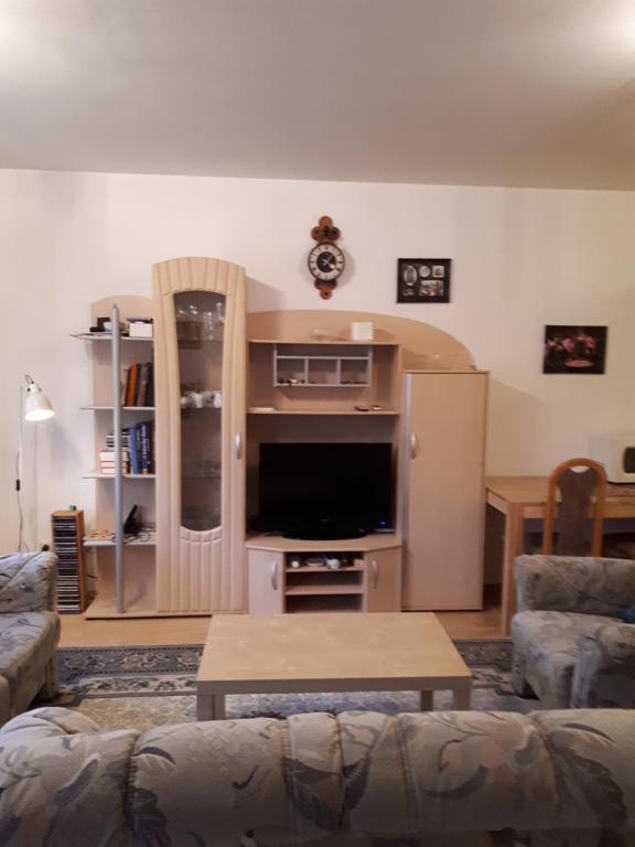 ein Wohnzimmer mit einem Sofa und einem Flachbild-TV in der Unterkunft Helmut Marx in Heimbach