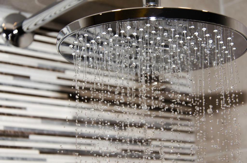 a shower with water pouring out of it at Talos Luxury Suites in Kounoupidhianá
