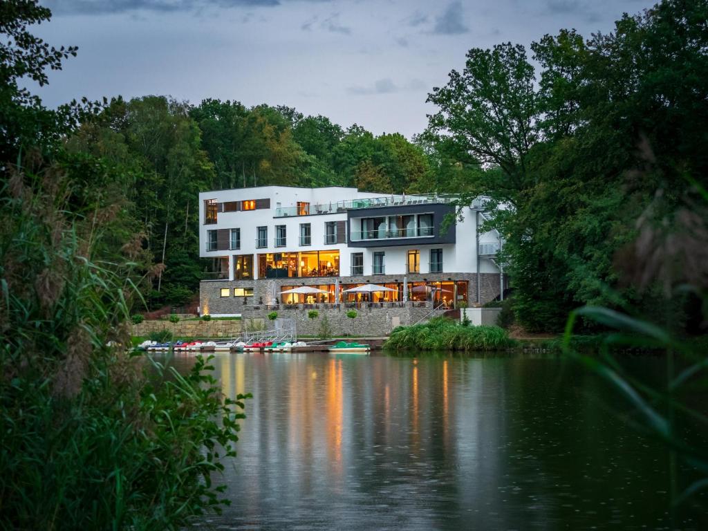 a building next to a river with boats in it at PETERS Hotel & Spa in Homburg