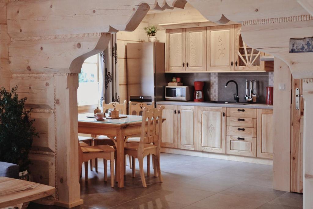 a kitchen with a table and chairs in a room at BIAŁY PUCH in Zakopane