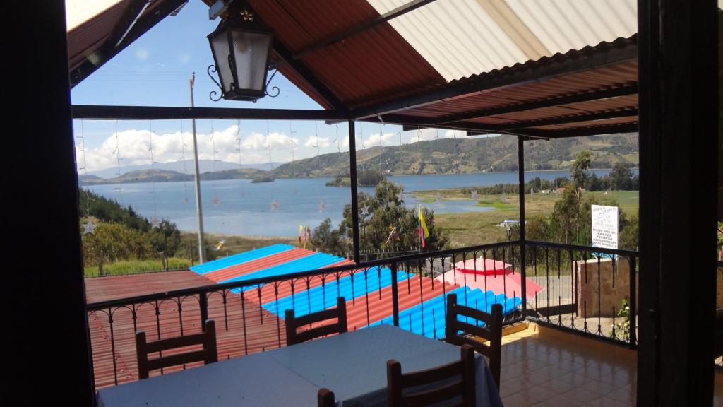 a balcony with a view of a swimming pool at Lago de Tota Las Heliconias in Aquitania