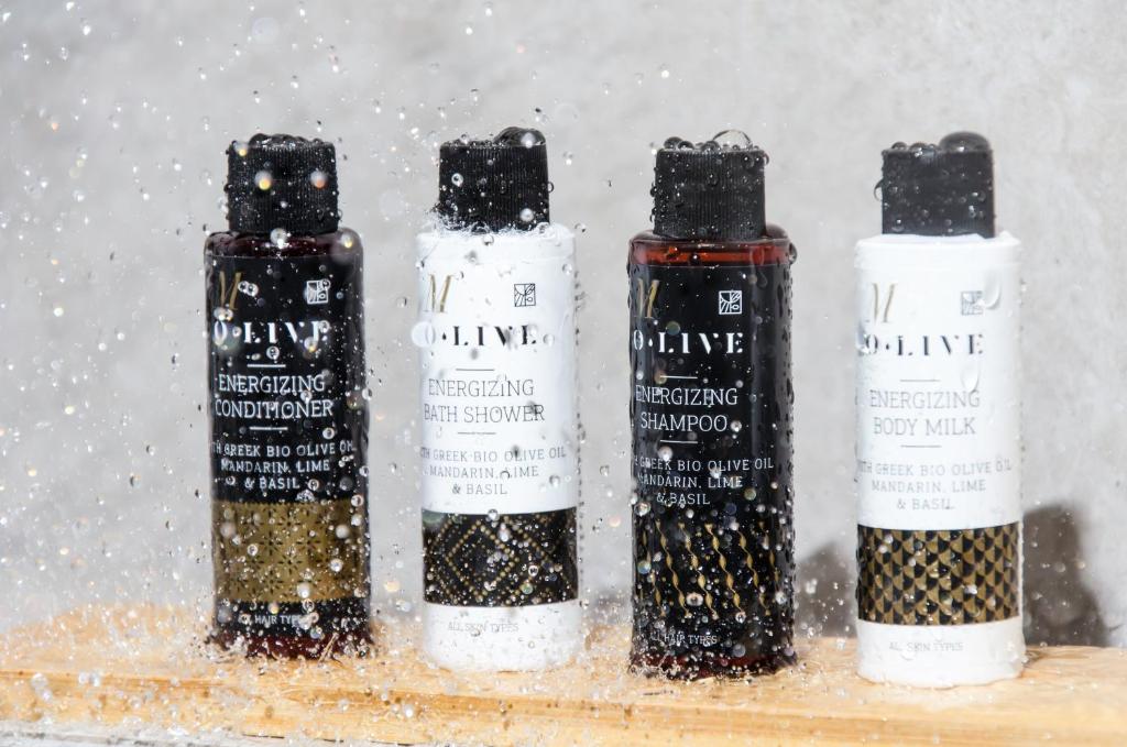 three bottles of wine on a shelf in the snow at Talos Luxury Suites in Kounoupidhianá