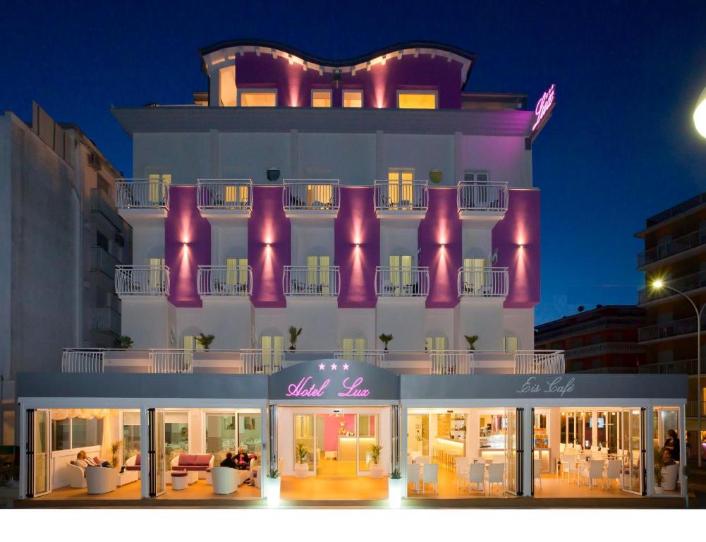 a store front of a hotel at night at Hotel Lux in Caorle