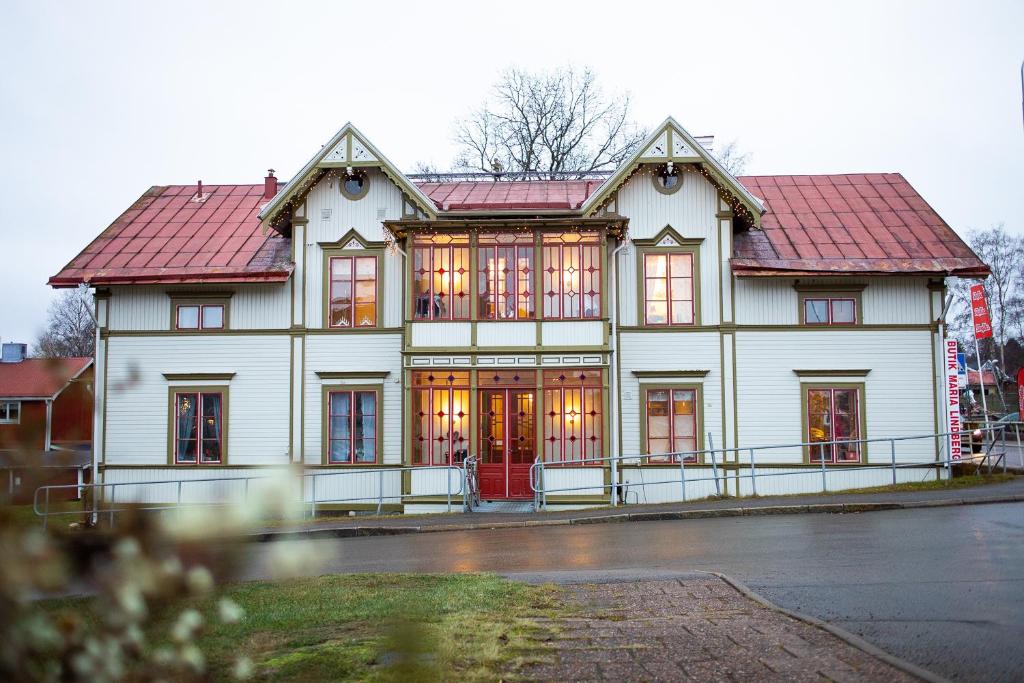 a large white house with a red roof at 58 Turistvägen Järvsö in Järvsö