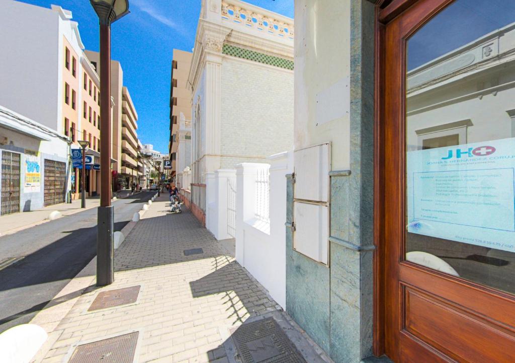 a building with a door on the side of a street at Rooms & Suites Loft 2G Deluxe Edition Arrecife in Arrecife