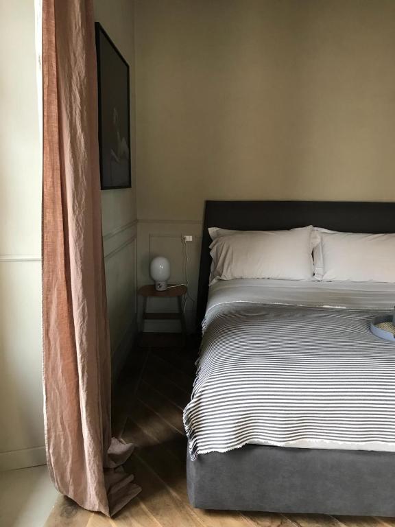 a bedroom with a bed with a black headboard at Suites Menaggio in Menaggio