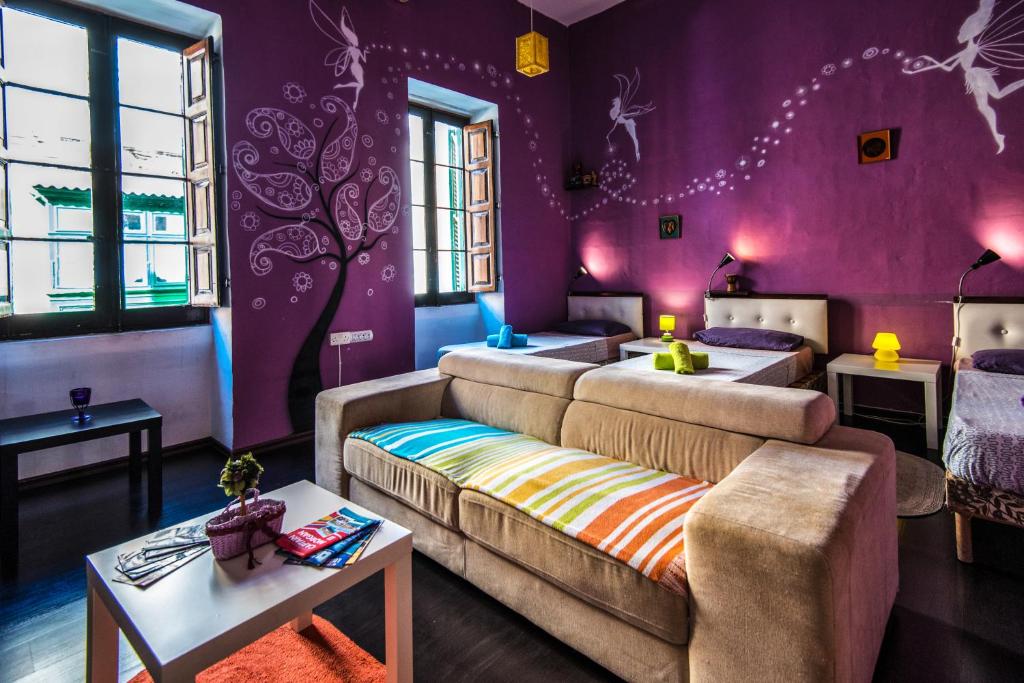 a living room with purple walls and a couch at Five Trees in Sliema
