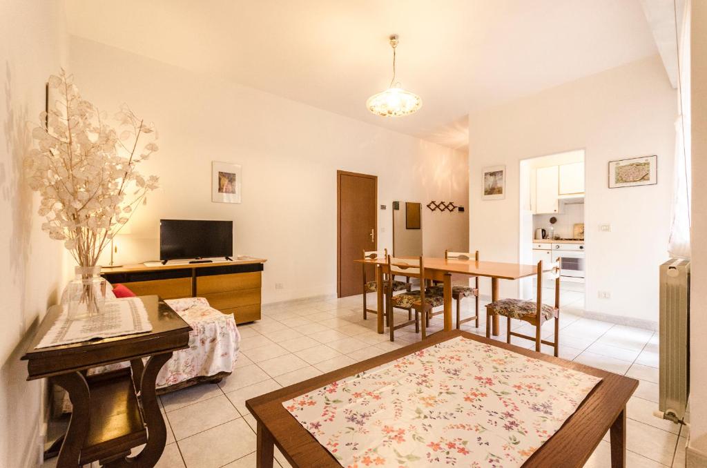 ein Wohnzimmer mit einem Tisch und einer Küche in der Unterkunft Romagnoli apartment in Bologna