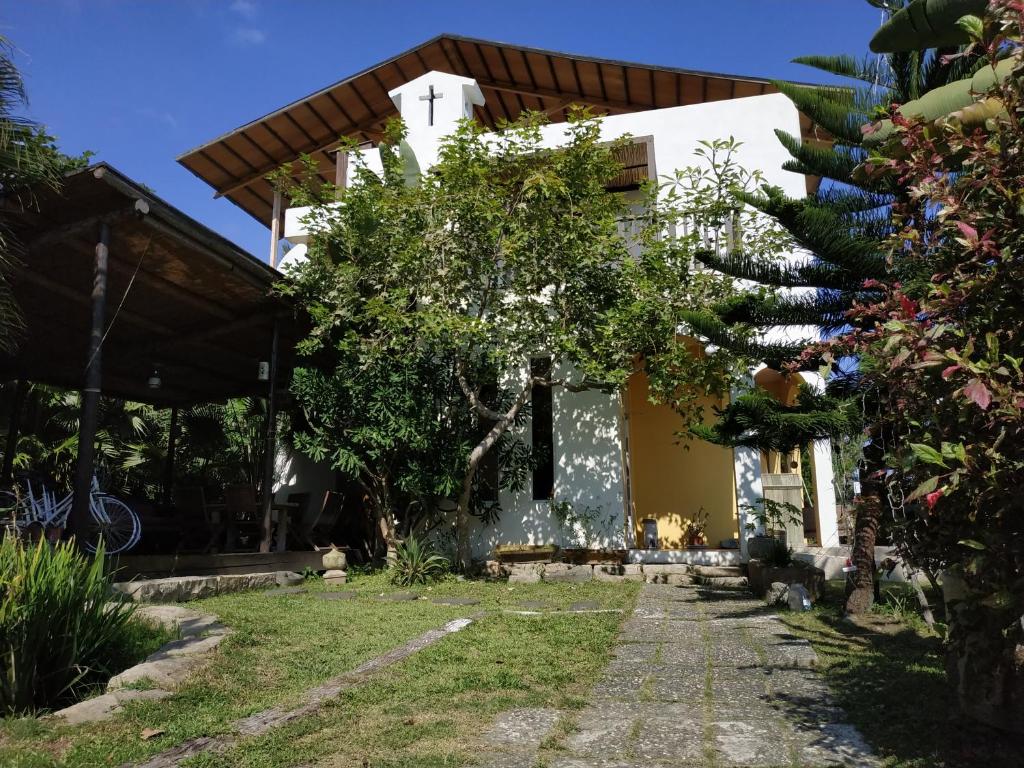 a house with a garden in front of it at Cenacle B &amp; B in Chenggong