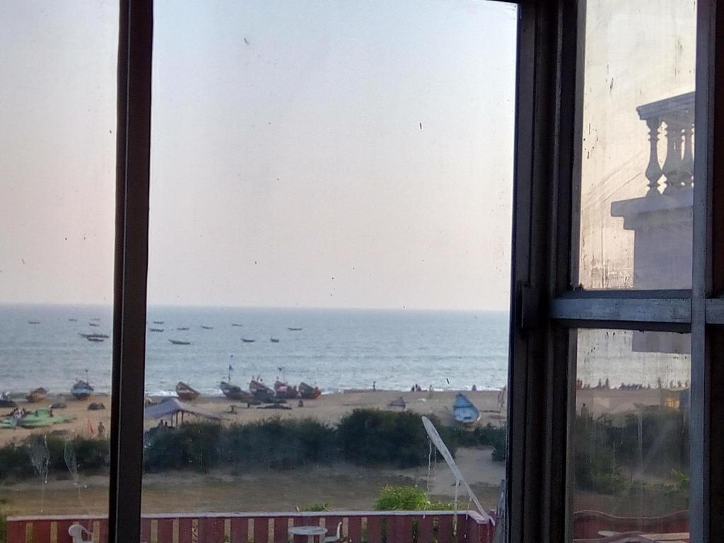 a view of the ocean from a window at NIRMAN beach homestay in Puri