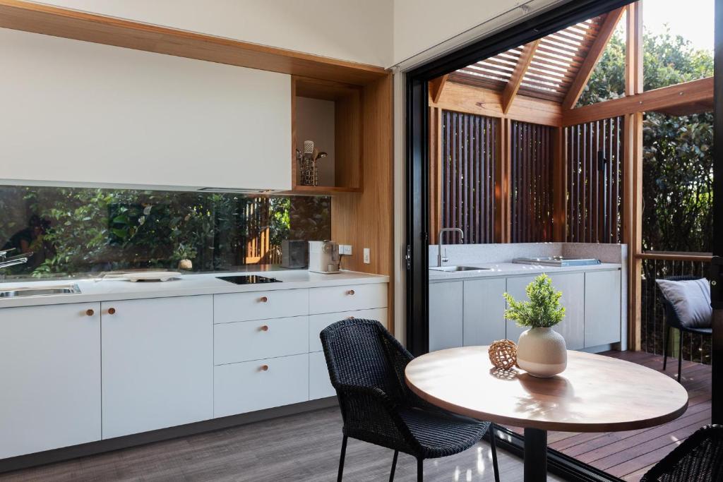 een keuken en eetkamer met een tafel en stoelen bij Reflections Evans Head - Holiday Park in Evans Head