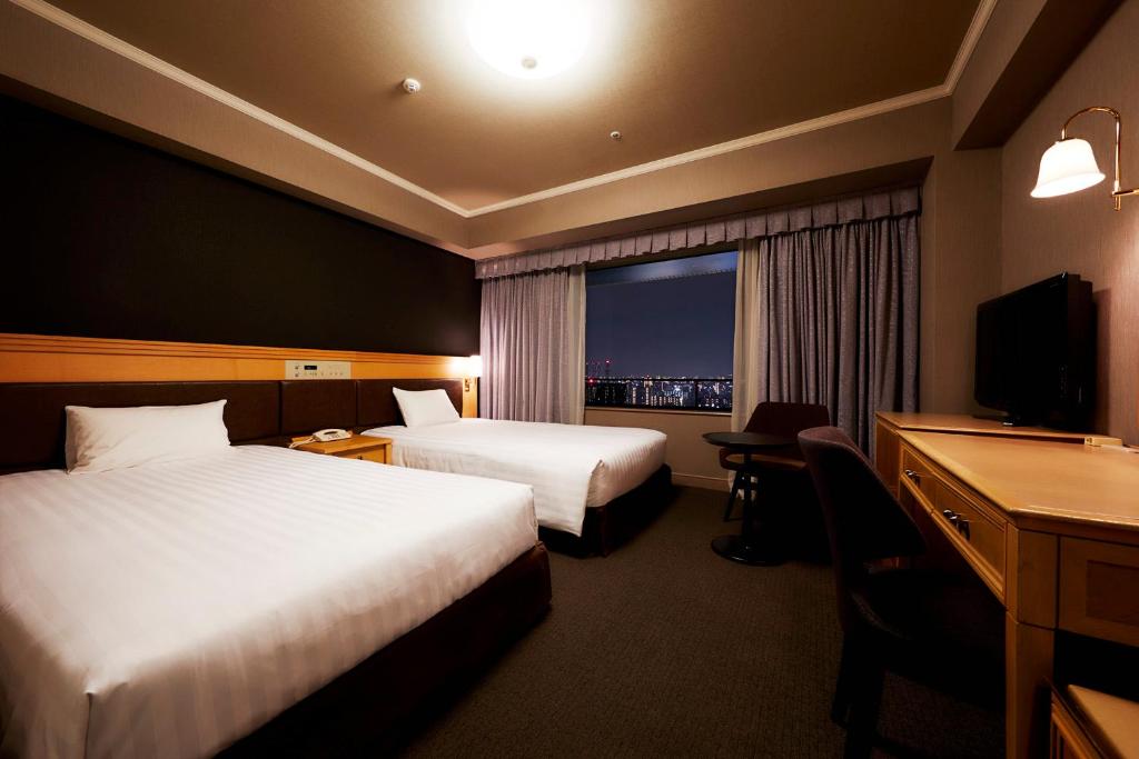 Postel nebo postele na pokoji v ubytování Hotel Agora Regency Osaka Sakai