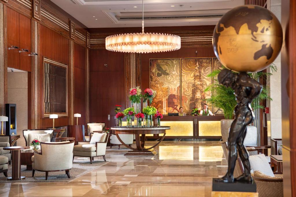 a lobby with a table with a globe on it at Stella Di Mare Dubai Marina Hotel in Dubai
