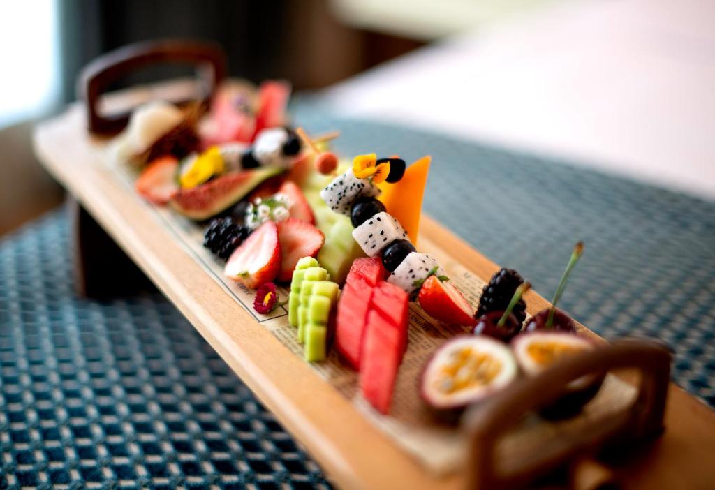 a plate of food with fruits and vegetables on a table at Stella Di Mare Dubai Marina Hotel in Dubai