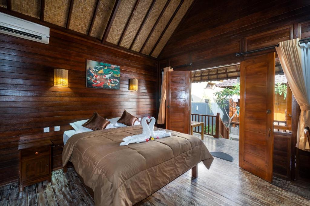 a bedroom with a bed with a towel on it at Krisna Home Stay in Nusa Lembongan