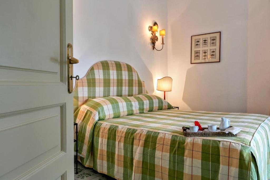 Postel nebo postele na pokoji v ubytování Palazzo Margherita