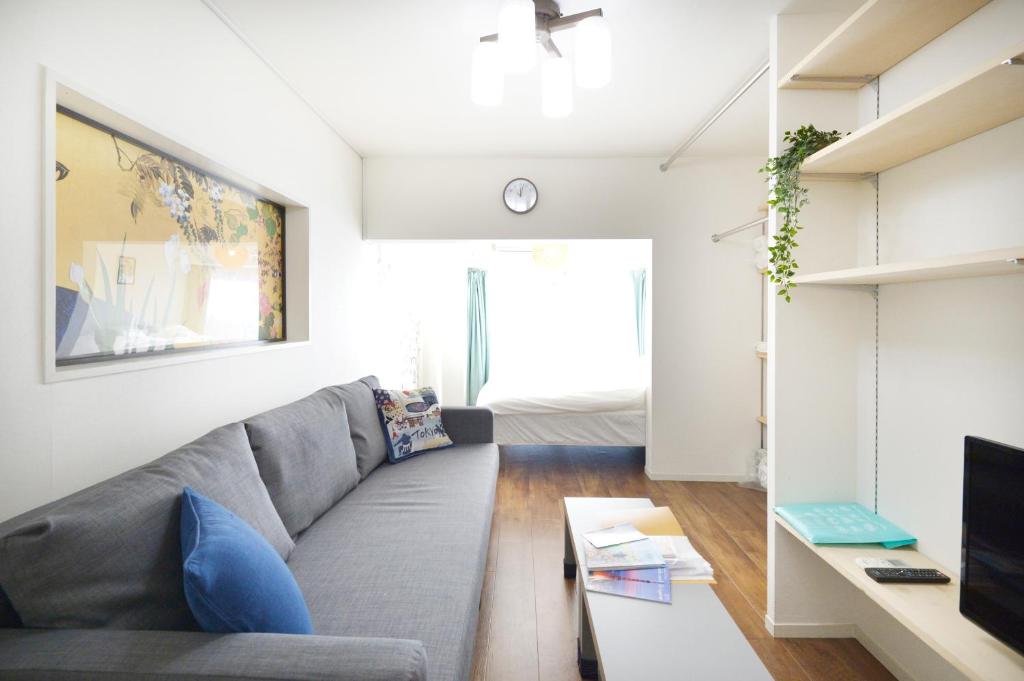a living room with a couch and a tv at Roppongi Japan House602 in Tokyo