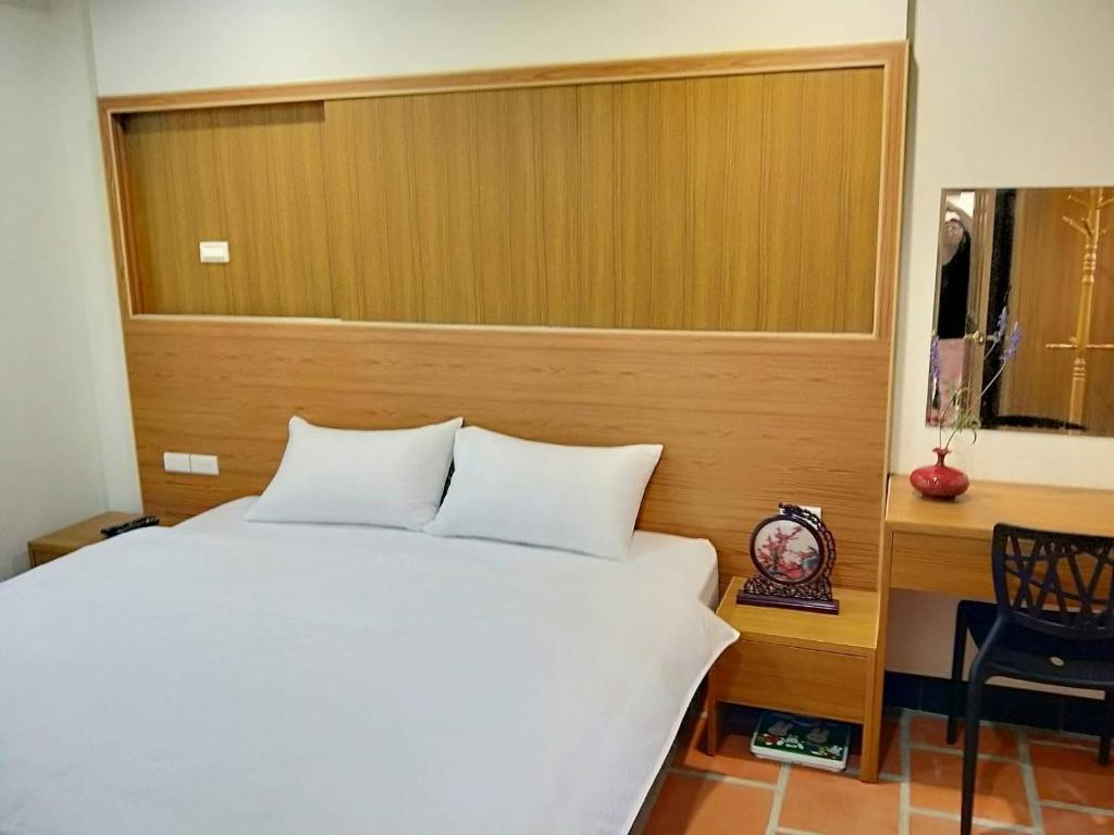 Postel nebo postele na pokoji v ubytování Kinmen Huquian 58