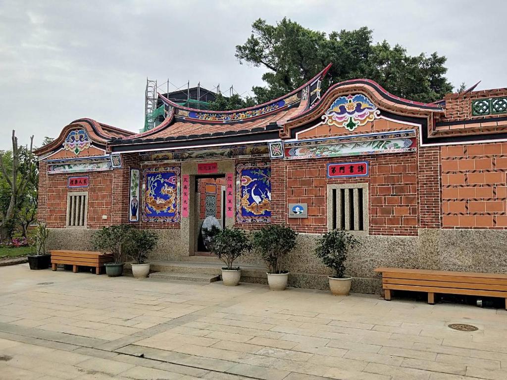 a brick building with benches in front of it at Kinmen Huquian 58 in Jinhu
