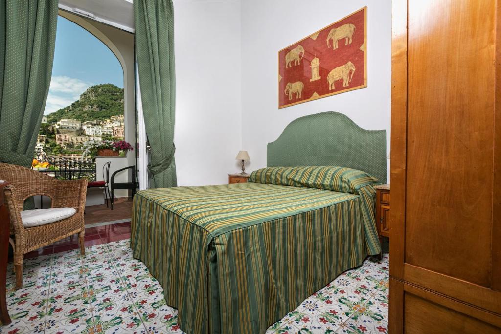 Postel nebo postele na pokoji v ubytování Palazzo Margherita