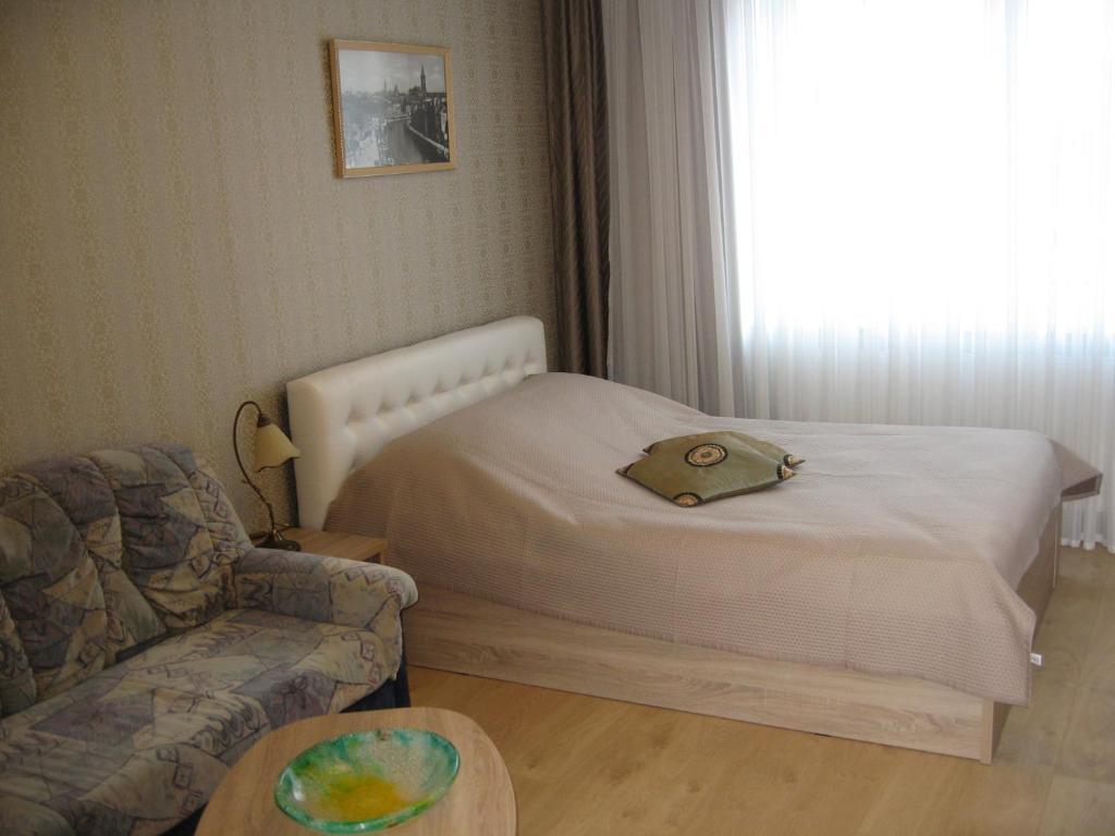 カリーニングラードにあるНа улице Зои Космодемьянскойの小さなベッドルーム(ベッド1台、ソファ付)
