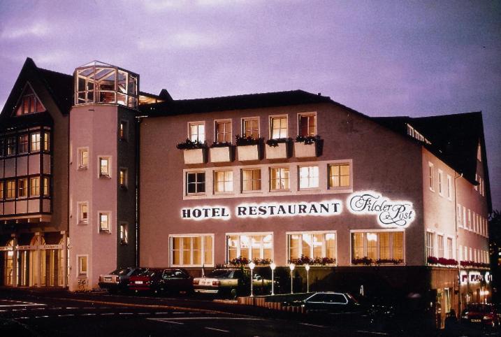 a large building with a sign on the side of it at Airport Hotel Filder Post in Stuttgart