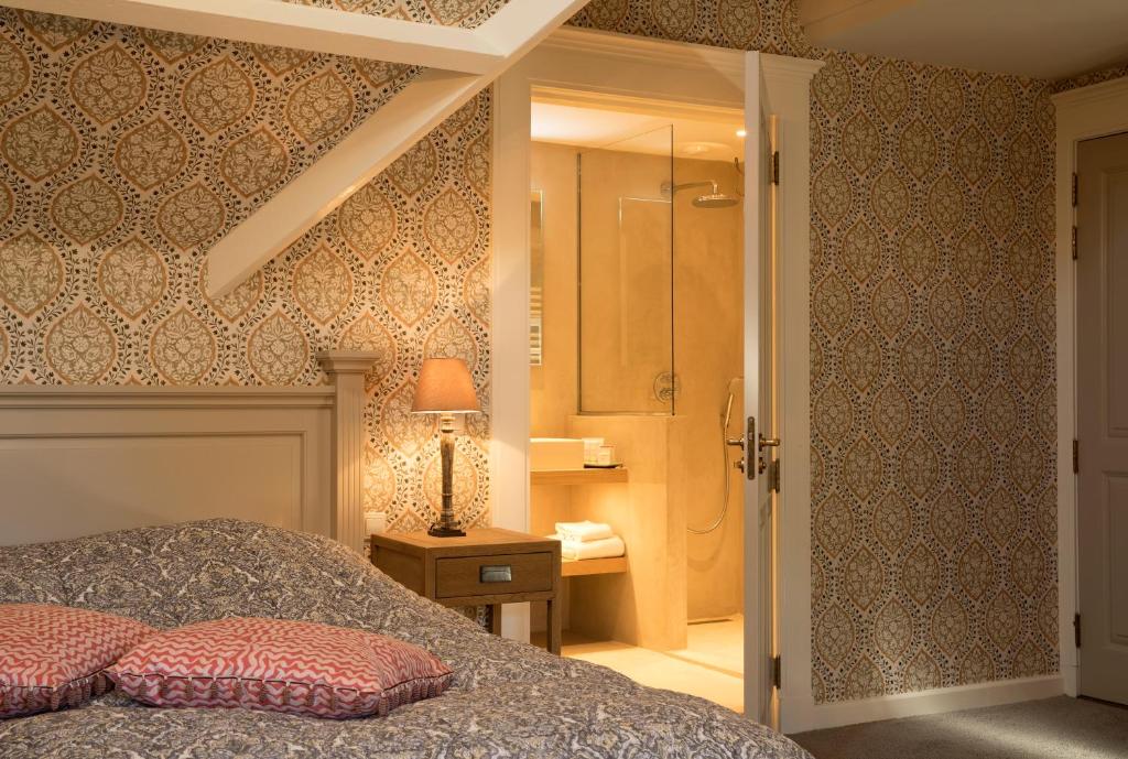 Postel nebo postele na pokoji v ubytování Relais & Chateaux Hotel Landgoed Het Roode Koper