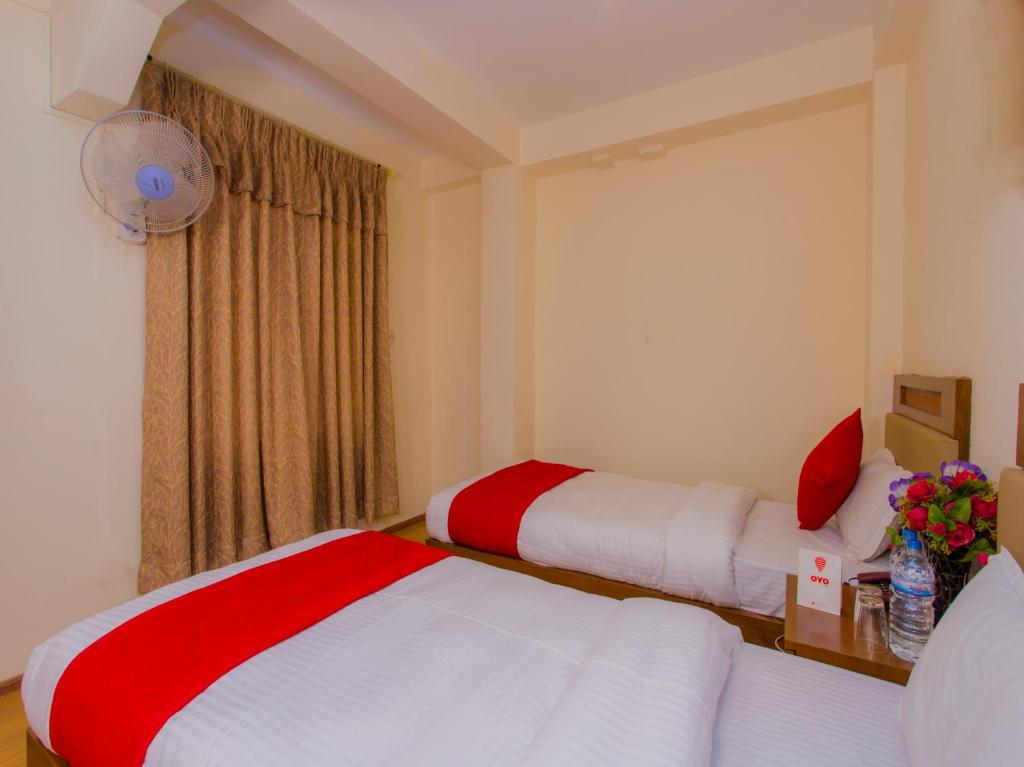 Postel nebo postele na pokoji v ubytování Durbar Guest House