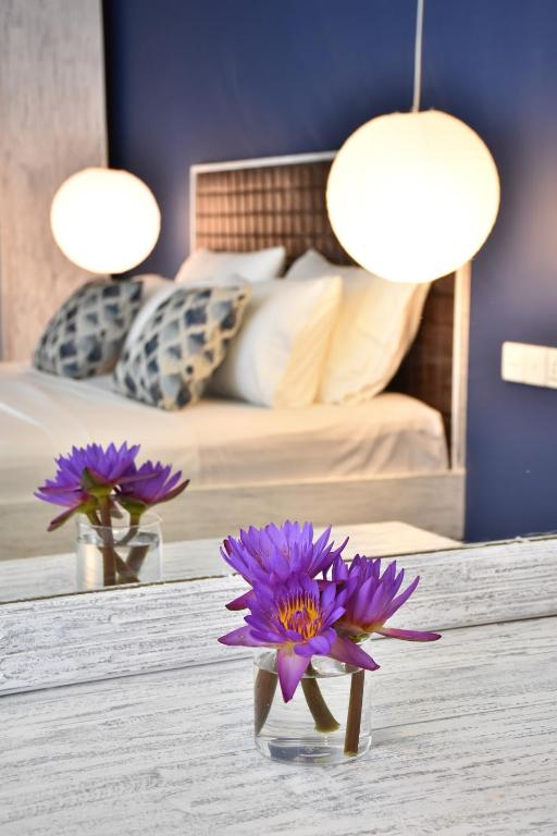a purple flower on a table in a bedroom at BeachMirissa Hotel in Mirissa