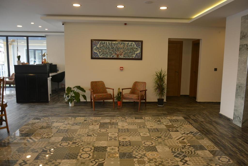 a lobby with chairs and a table and a picture on the wall at Eleia Hotel İznik in Bursa