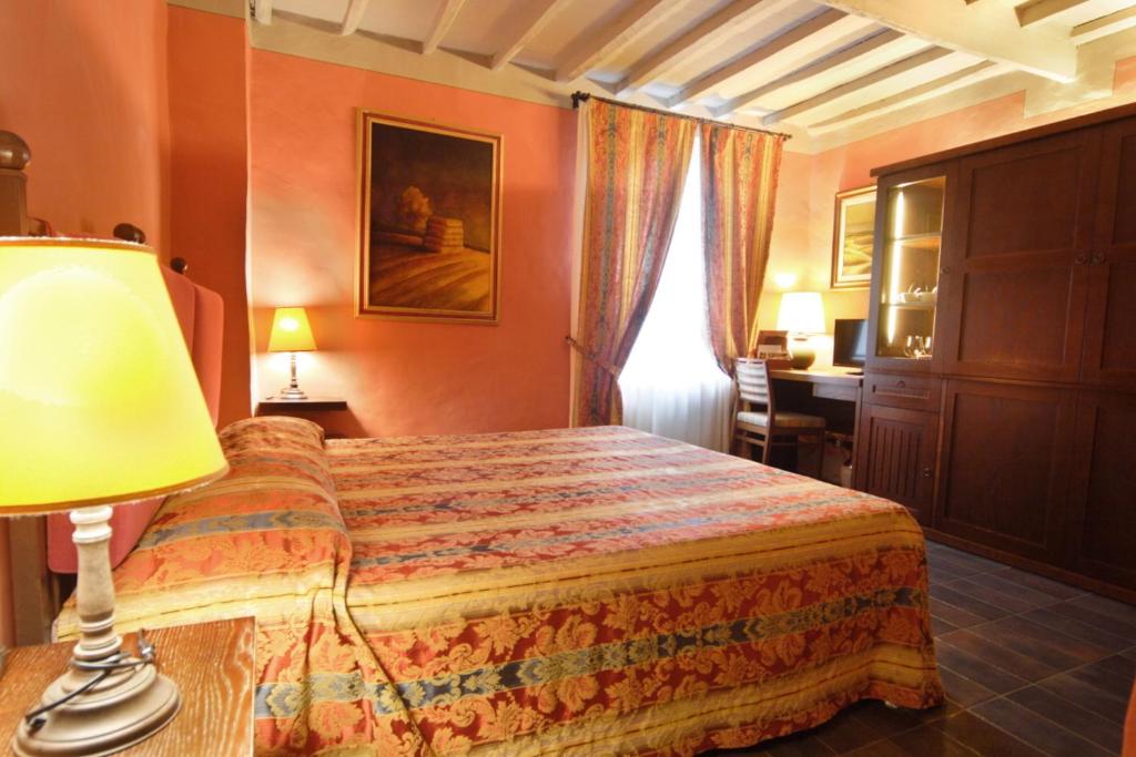 Postel nebo postele na pokoji v ubytování Locanda Viani