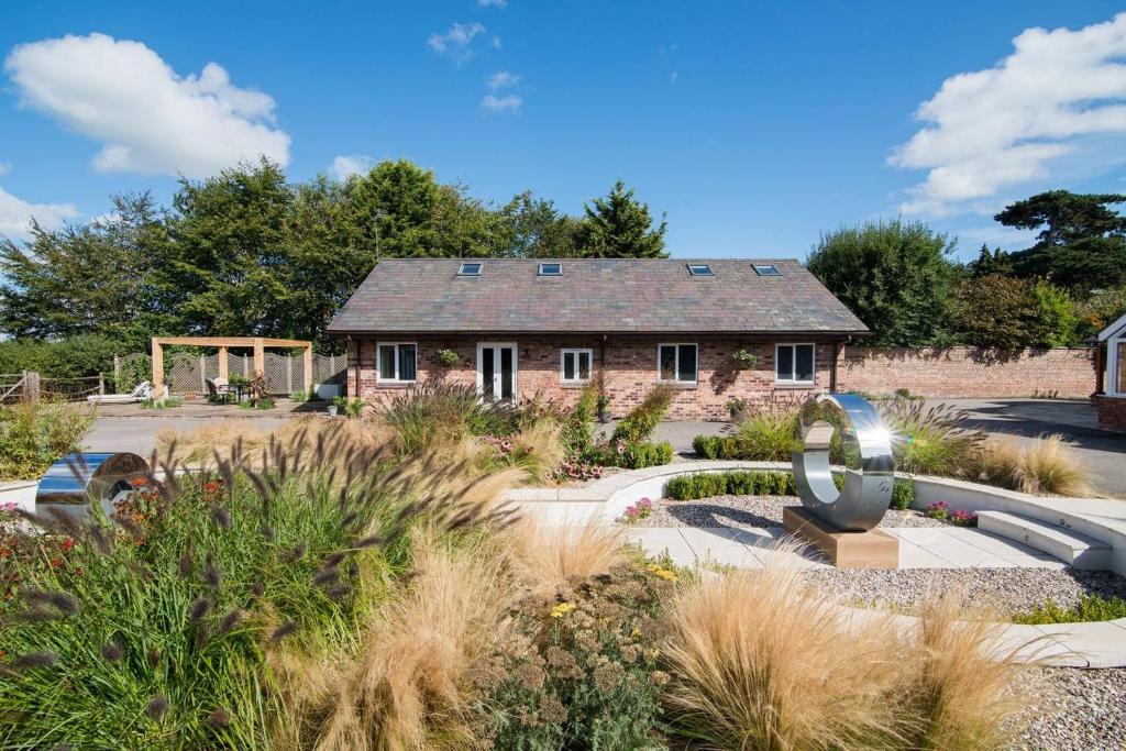 a stone house with a sculpture in front of it at Hillside House in Chester