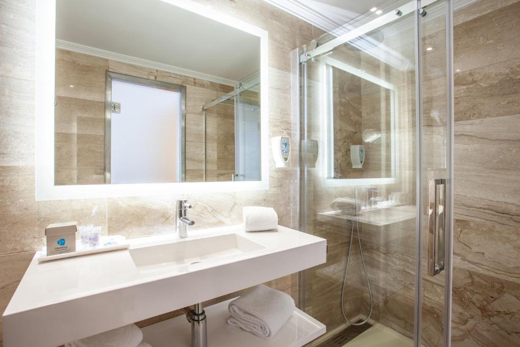 a bathroom with a sink and a shower at Grupotel Los Príncipes & Spa in Playa de Muro