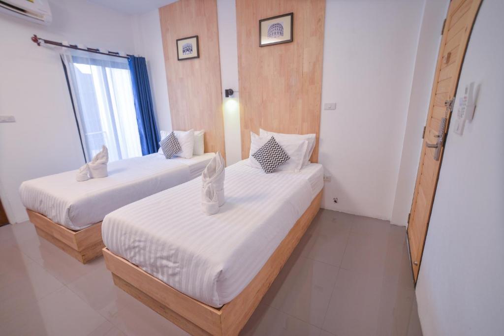 Postel nebo postele na pokoji v ubytování The Cozy Hotel