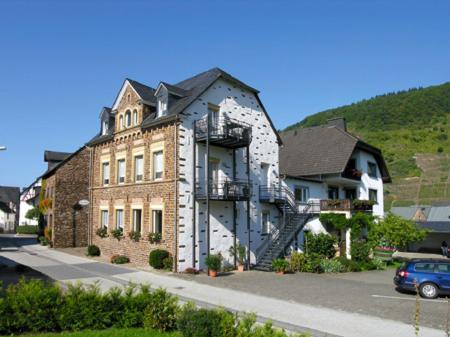 a large brick building with a staircase on the side of it at Ferienweingut Gansen Hochgenuss 2 in Ernst