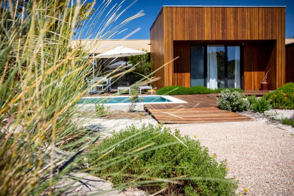 a house with a swimming pool in a yard at Pestana Troia Eco-Resort & Residences in Troia