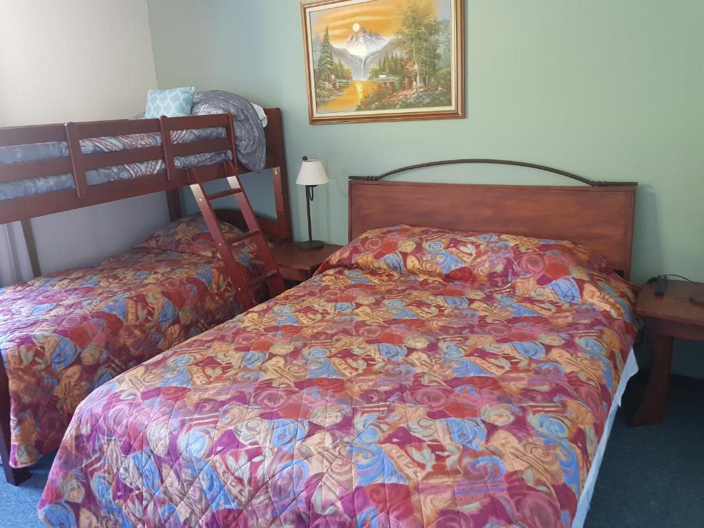a bedroom with a bed with a colorful comforter at The Paradise of Atitlán Suites apartamento completo in Panajachel