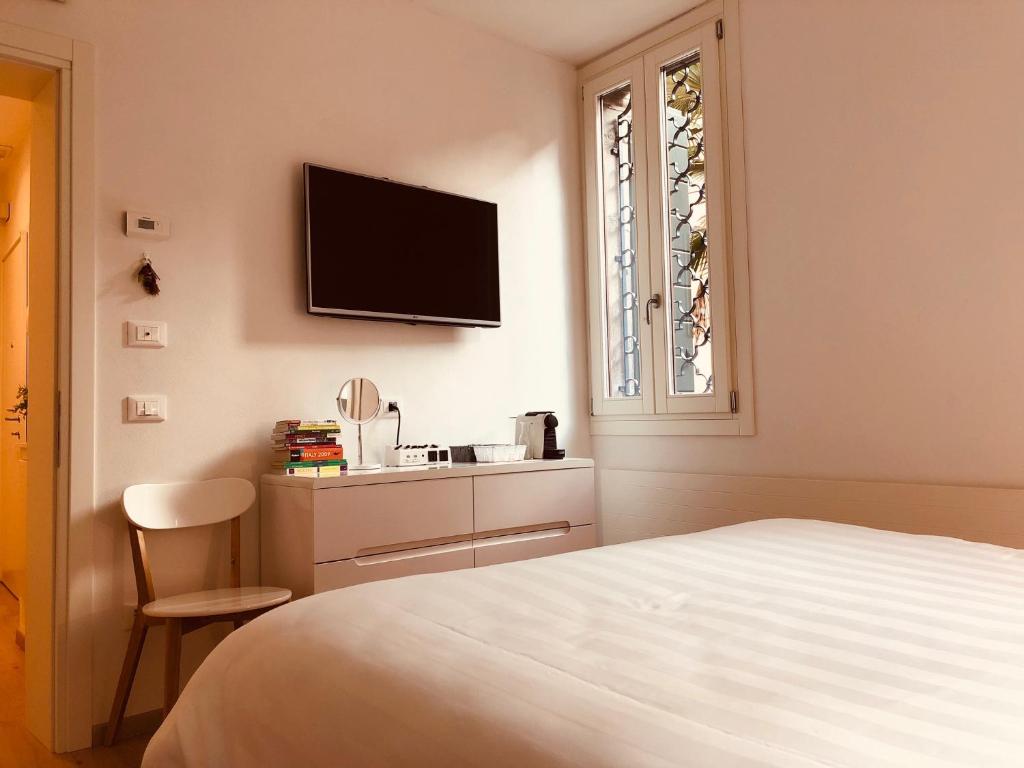A bed or beds in a room at San Marco Design Suites