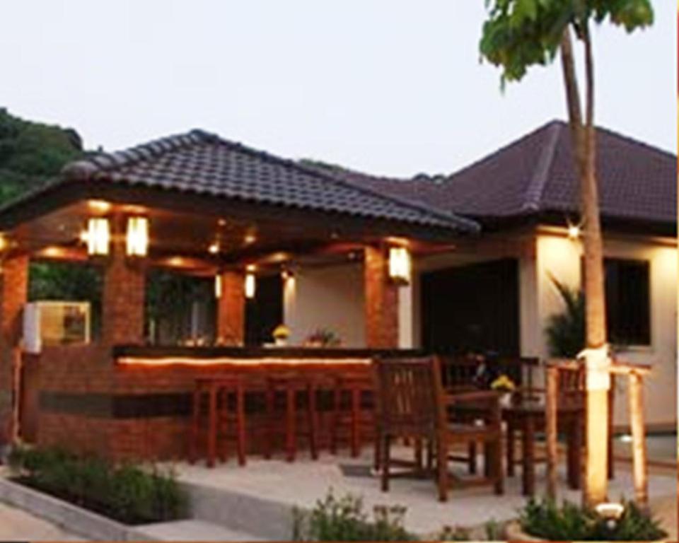 a house with a patio with a table and chairs at Katanoi Resort in Kata Beach