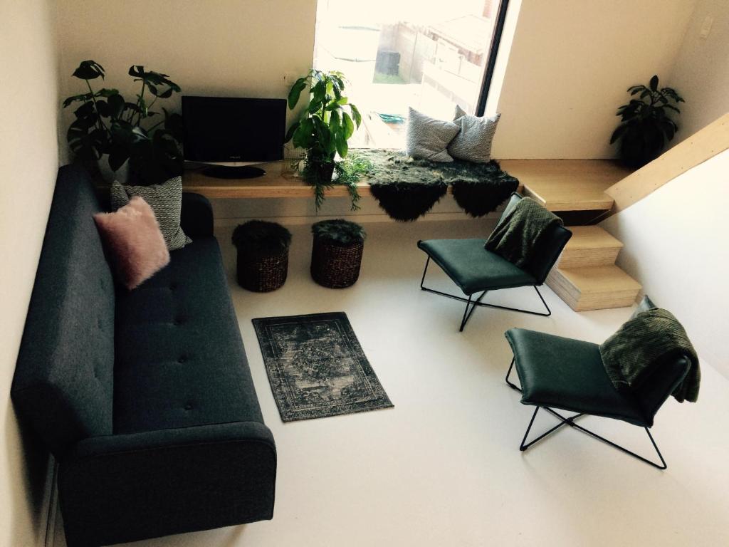 a living room with a couch and two chairs at Nelly in Ypres