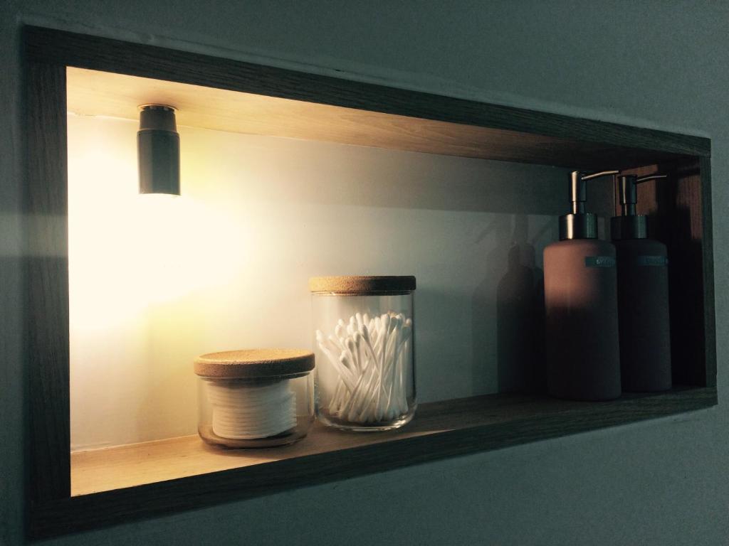 a shelf with a glass jar and other items on it at Nelly in Ypres