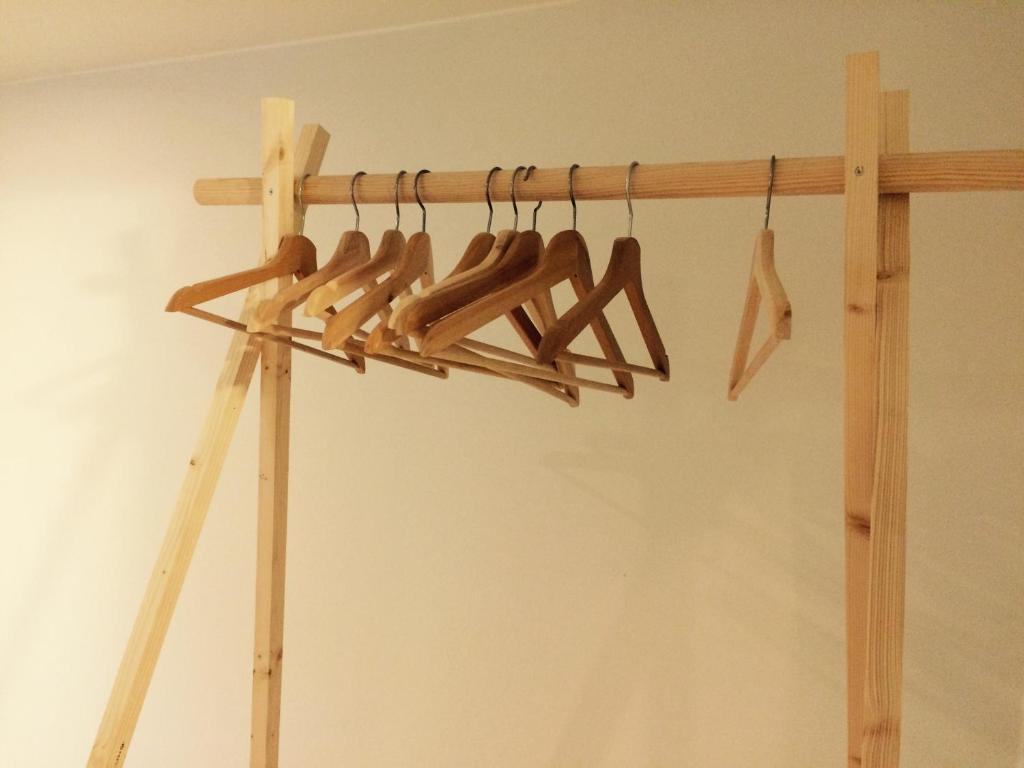a group of wooden baseballoons hanging on a rack at Nelly in Ypres